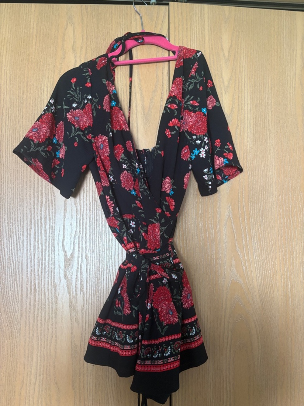 Miami Black Floral V-Neck Romper with Red Blooms from Francesca’s